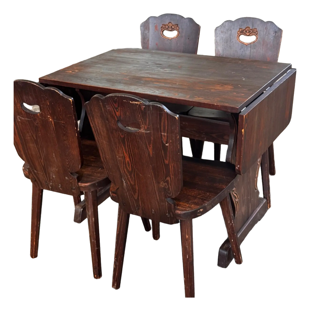 Dark wooden drop-leaf dining table with four chairs