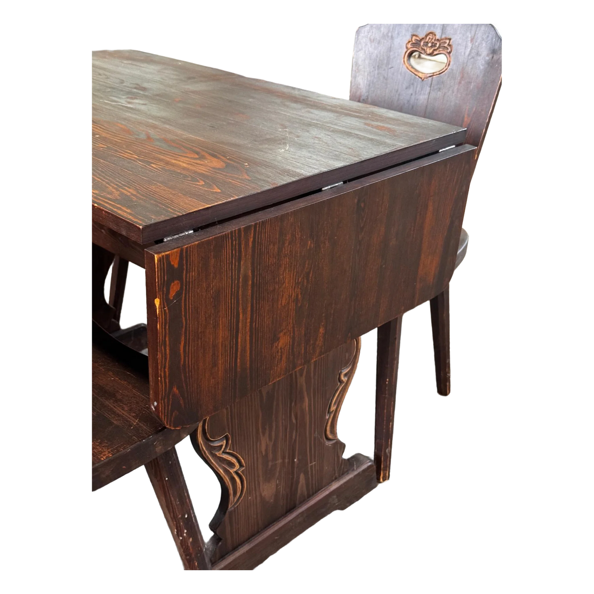 Dark wooden drop-leaf dining table with four chairs
