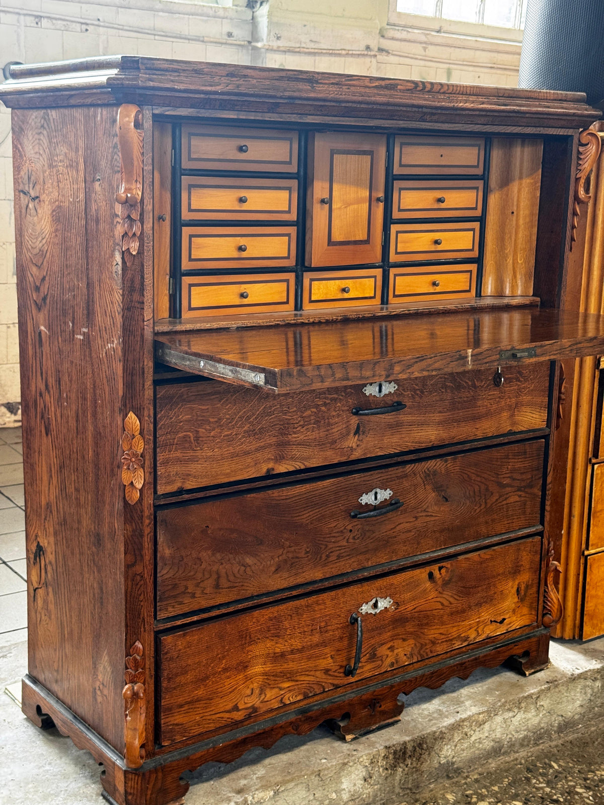 Wooden secretary desk with carved details and internal drawers